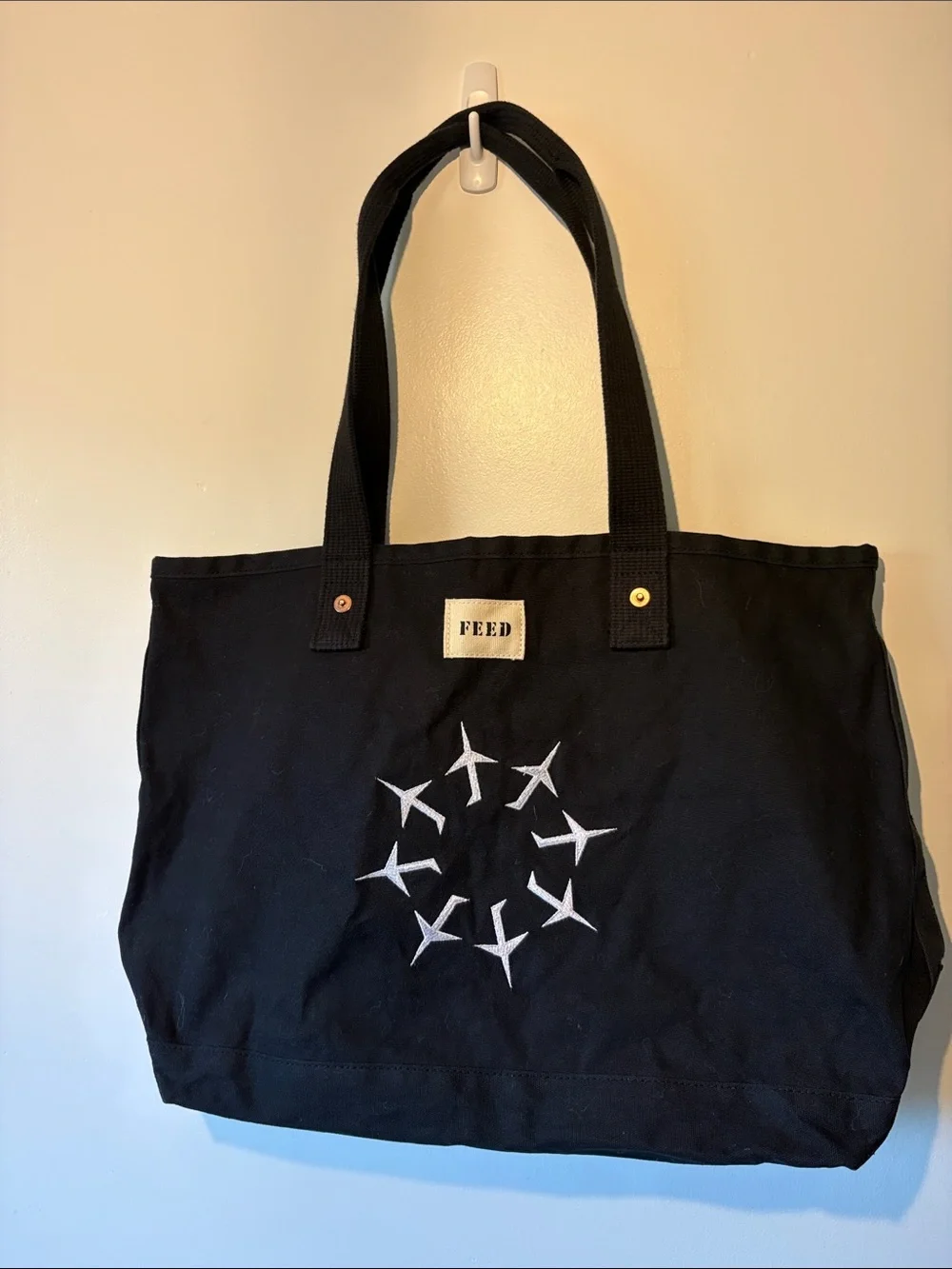 FEED Black Canvas Tote with Airplane Circle Graphic
